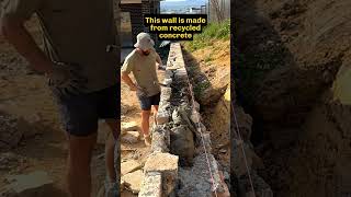 Stonemason places the final stones in a wall mason stonemason retainingwalls [upl. by Lenna]