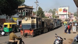 Narrow gauge train on road crossing of Gwalior light railway in Ghosipura India kereta api EIN079460 [upl. by Noemad80]