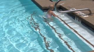 Toddler playing on the Swimming pool stairs and swimming in the water [upl. by Verda]