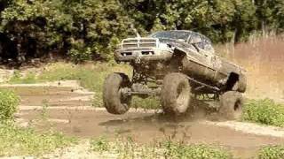 EPIC MUD JUMP HUGE DODGE CUMMINS DIESEL 4x4 MUD TRUCK on 54quot BOGGERS [upl. by Darton]