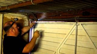 How to adjust the spring tension on a garage door in Manchester [upl. by Olenka]